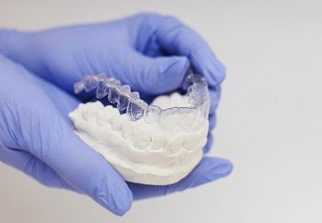 Professional showcasing custom mouthguards in Madera