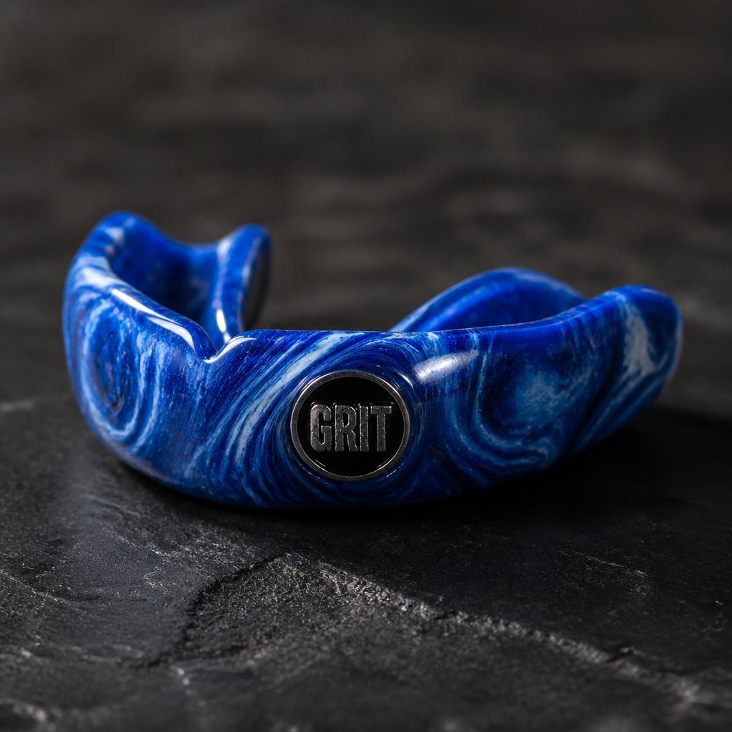 Custom royal blue marble team mouthguard with GRIT crest