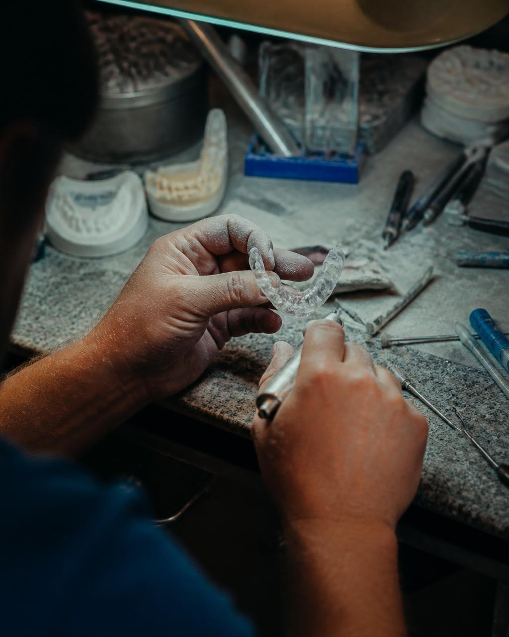 Hand-finishing a custom mouthguard at The Grit Lab